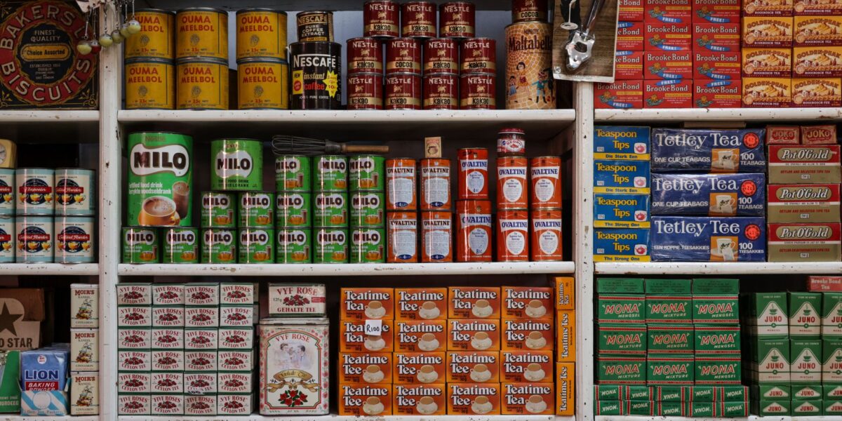 A nostalgic view of vintage grocery store shelves filled with assorted food products and drinks.