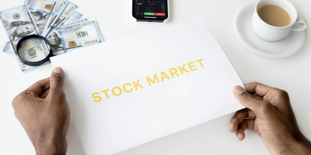 Business theme with stock market document, currency, and mobile display.