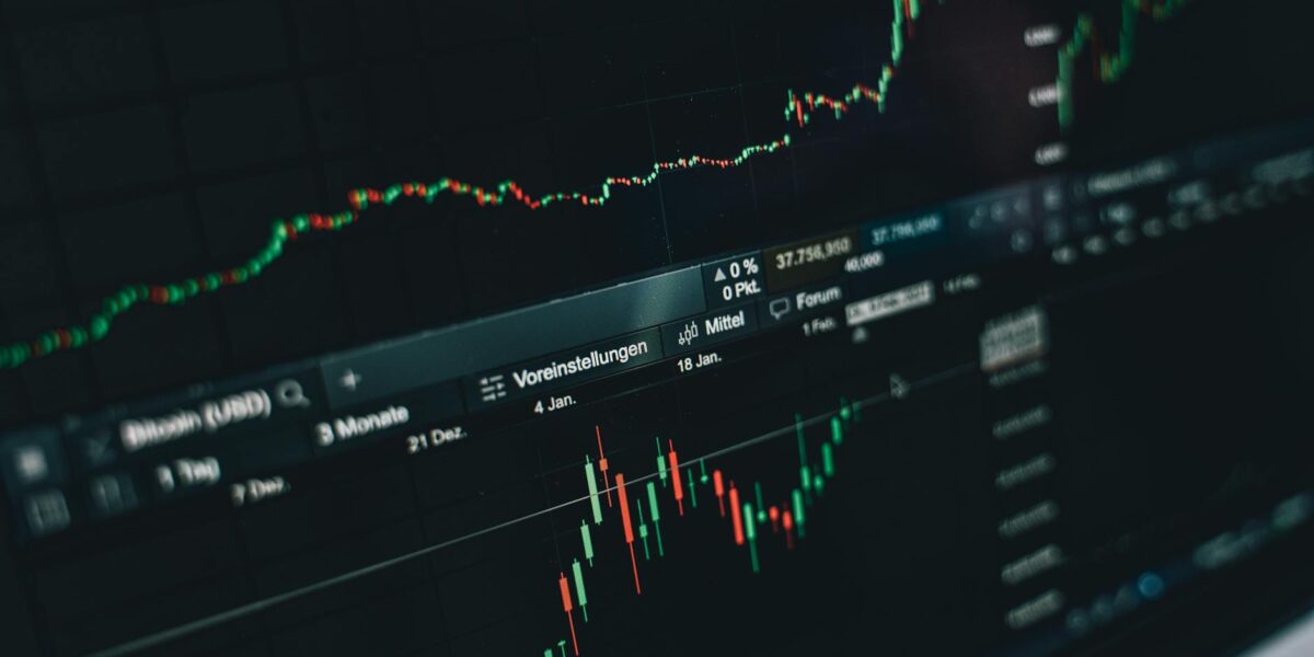 Close-up of a digital market analysis display showing Bitcoin and cryptocurrency price trends.
