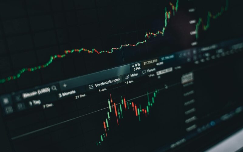 Close-up of a digital market analysis display showing Bitcoin and cryptocurrency price trends.