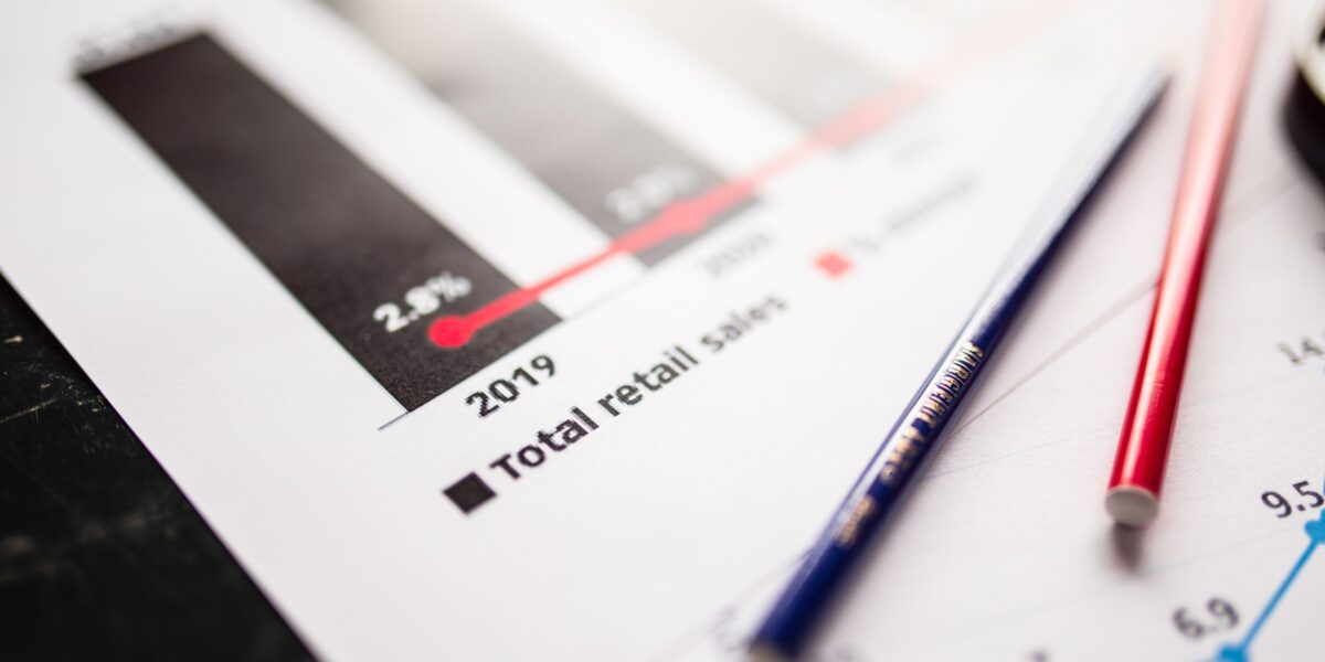 Detail view of retail sales chart and pencils on desk, showcasing data analysis.