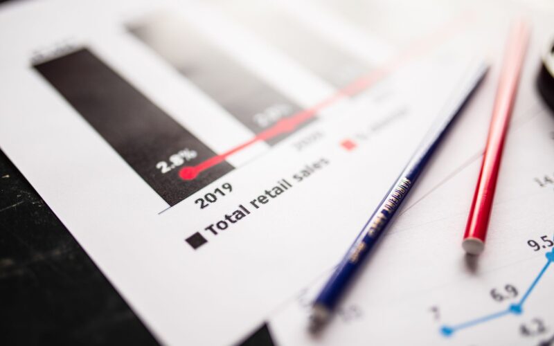 Detail view of retail sales chart and pencils on desk, showcasing data analysis.