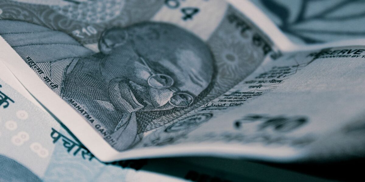 Detailed close-up of Indian Rupee banknotes with iconic Gandhi portrait, emphasizing economy and currency themes.