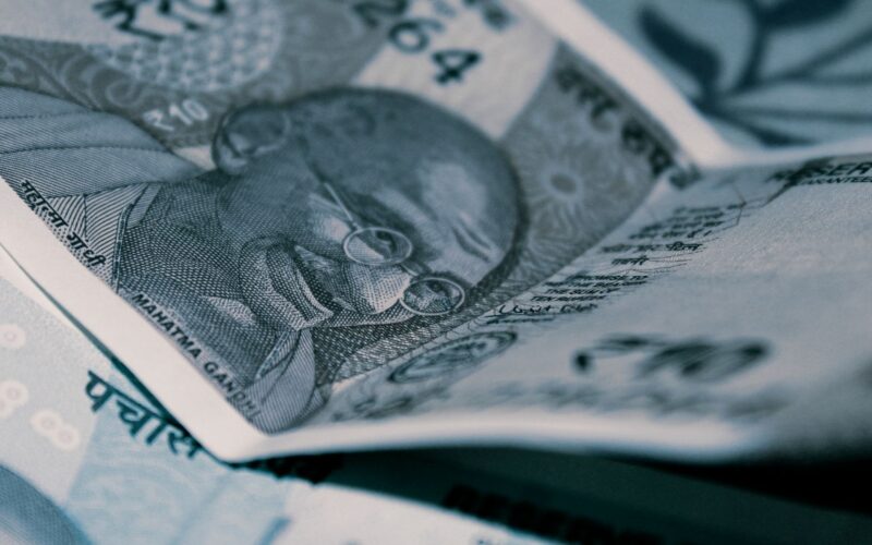 Detailed close-up of Indian Rupee banknotes with iconic Gandhi portrait, emphasizing economy and currency themes.