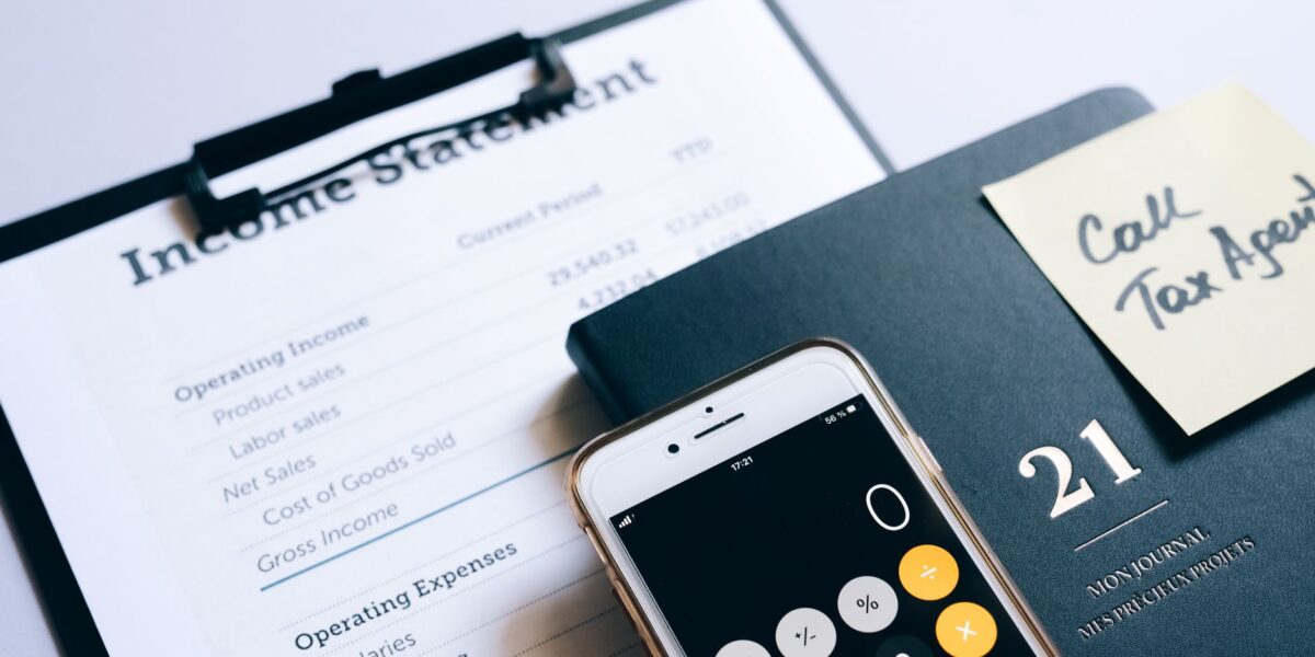 Close-up of income statement, calculator, and planner for financial planning.