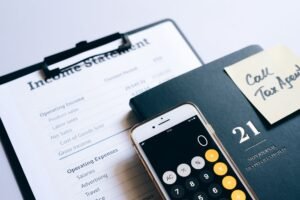 Close-up of income statement, calculator, and planner for financial planning.