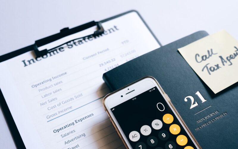 Close-up of income statement, calculator, and planner for financial planning.