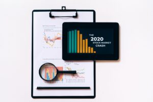 Tablet and clipboard with charts illustrating the 2020 stock market crash.