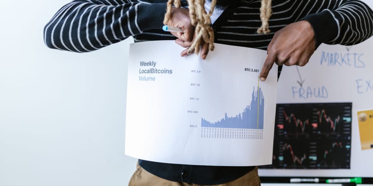 Businessperson presenting a chart on weekly Bitcoin volume trends with detailed analysis.