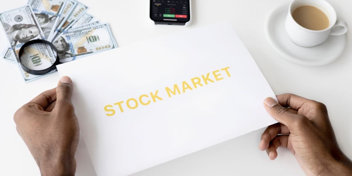Business theme with stock market document, currency, and mobile display.