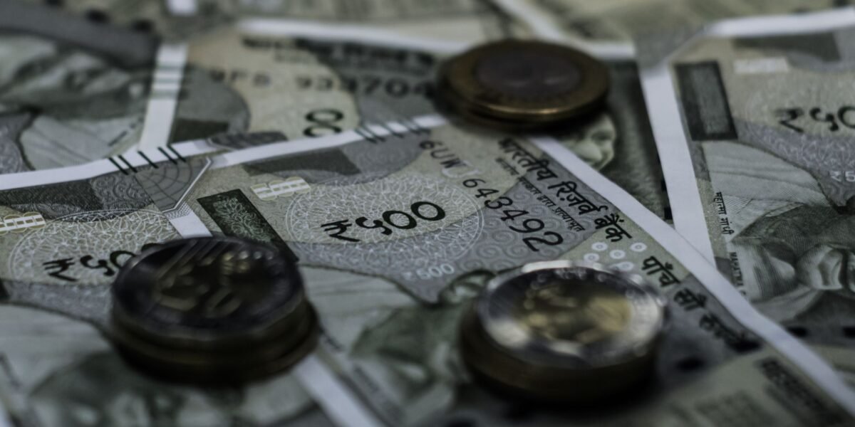 Detailed view of Indian currency notes and coins representing wealth and finance.