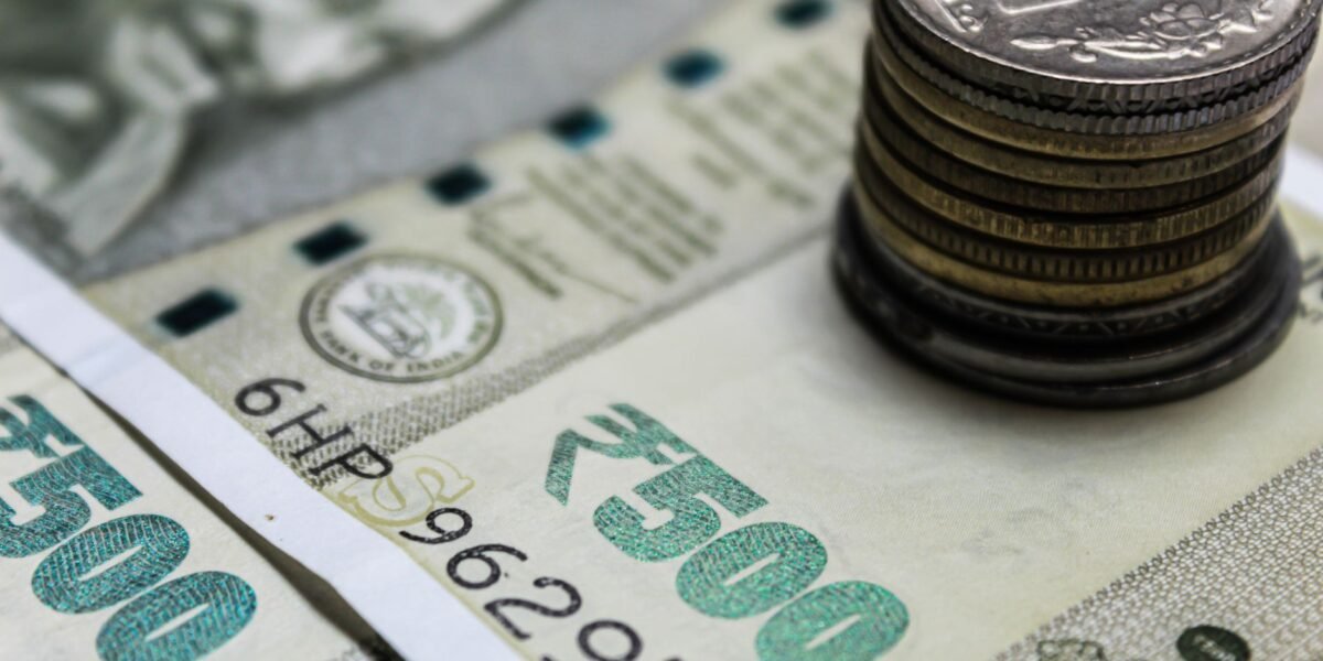 Detailed view of Indian rupees and stacked coins, representing currency and finance.