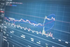 Close-up of a financial graph on a screen showing stock market trading data and trends.
