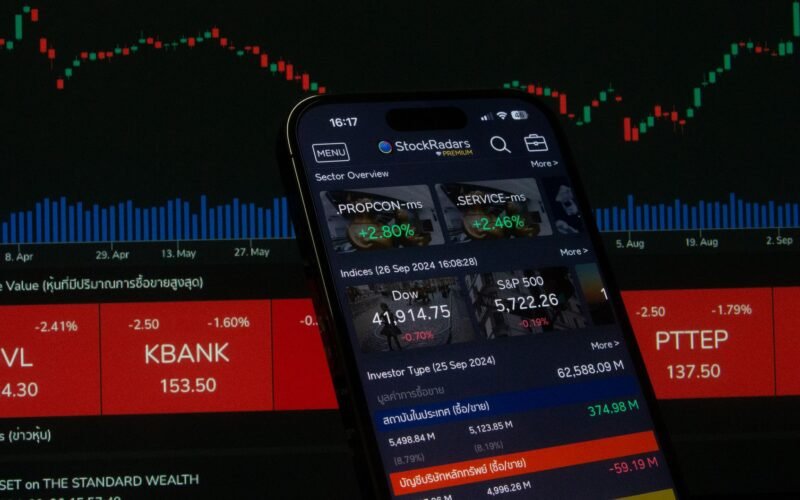 Close-up of a digital stock trading app interface with investment charts and market trends displayed.