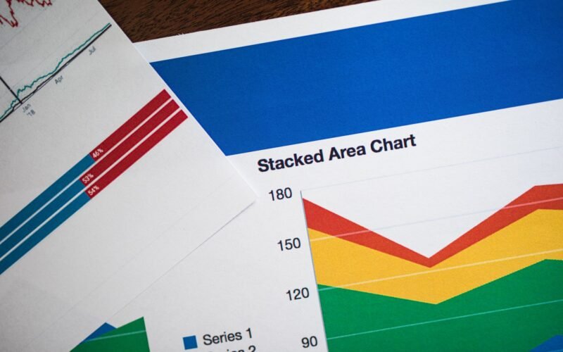 Vivid stacked area chart and graphs on paper, showcasing data analysis.