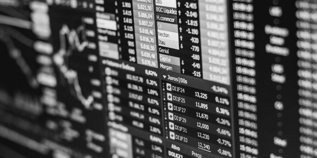 Monochrome image of stock market data on a screen, depicting financial information and trends.