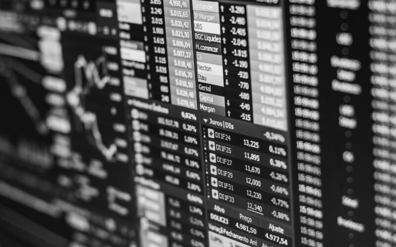 Monochrome image of stock market data on a screen, depicting financial information and trends.