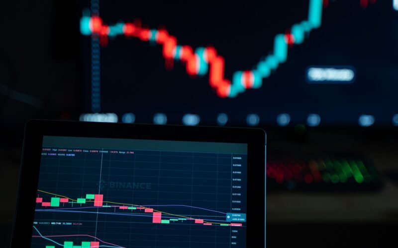 Detailed view of cryptocurrency trading charts on digital screens, showcasing market fluctuations.
