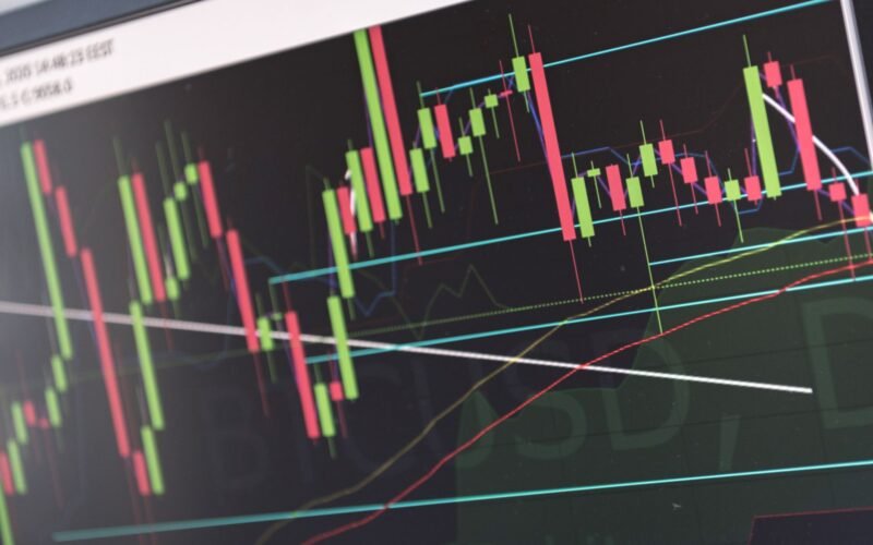 Close-up of vibrant stock market graphs displaying trading trends on a monitor, ideal for finance and cryptocurrency concepts.